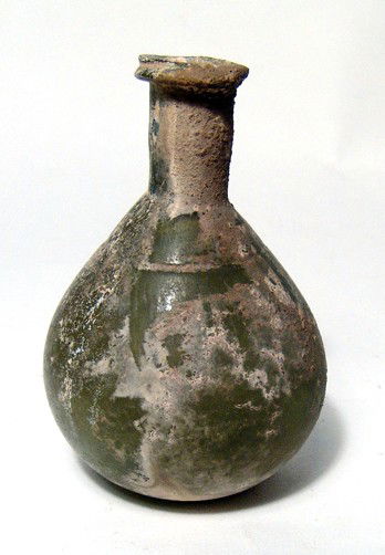 Roman glass bottle, Ex-museum deaccession: A Roman green glass pear-shaped bottle, 1st - 2nd Century BC, with wheel-cut line around shoulder. The rim is lightly flared, the rim pinched in and raised up. Intact with patches of iridescence. H: 3