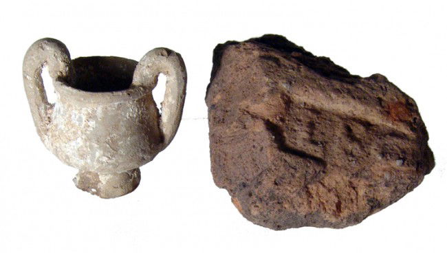 Roman legionary tile and miniature amphora: A stamped part of a legionary tile and a miniature amphora, Roman, c. 1st - 3rd Century AD. The partial terracotta tile with part of the stamp showing, LEG. 3 3/8" x 2 3/4" (8.5 x 7.2 cm). The small a