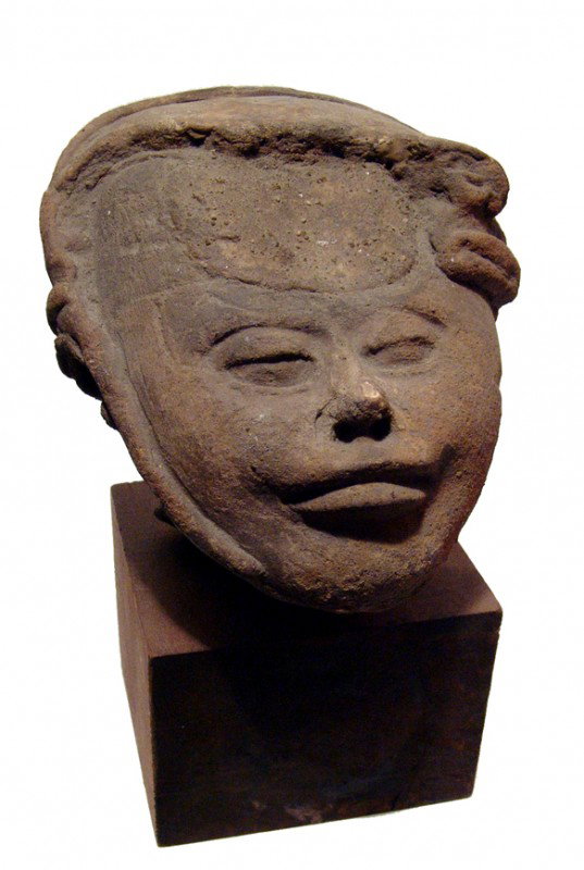 A large Terracotta Vera Cruz head: A large Terracotta Vera Cruz head, ca. AD 550 - 950, the facial features nicely rendered. Part of headdress with some old restoration. H: 5" (12.7 cm). Mounted on a custom base. Ex old Los Angeles col