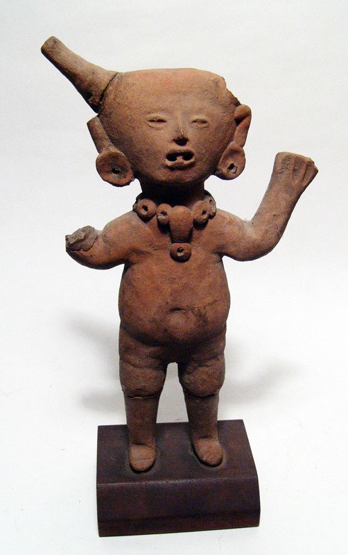 Standing Vera Cruz figure, West Mexico: A standing Vera Cruz figure, West Mexico, ca. 300 - 100 BC, his hands held aloft and wearing spiked headdress. Nicely detailed facial features with ear spools and a large beaded necklace. Some losses 