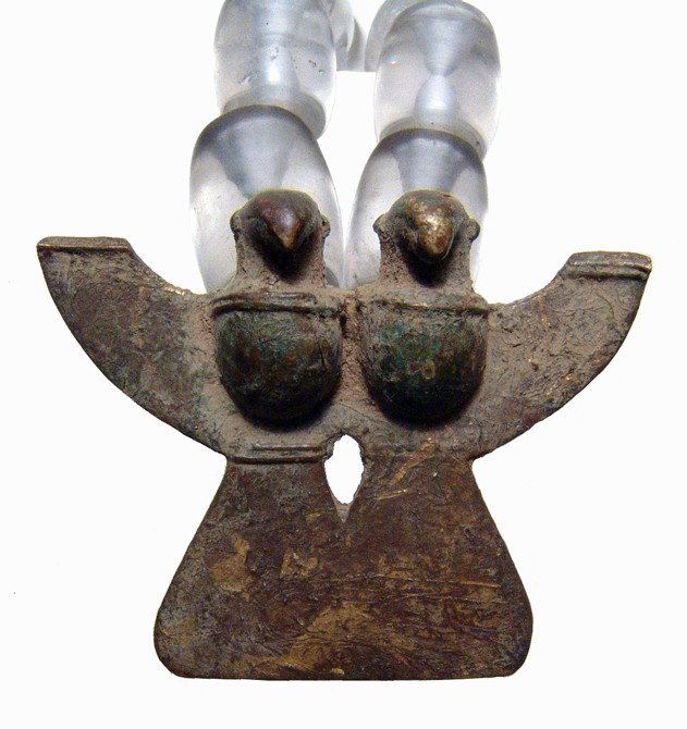 Necklace of Sinu quartz beads, tumbaga pendant: A necklace of Sinu quartz beads and a tumbaga pendant, Colombia, ca. AD 300 - 1,550. The clear quartz beads are barrel-shaped and nicely polished. The pendant in the form of two stylized birds and is 