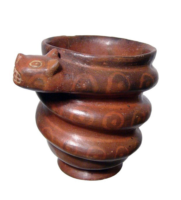 Huari kero with a feline-headed serpent: A nice red-ware Huari kero entwined by a feline-headed serpent, Peru, ca. AD 1,300 - 1,500, the body of the vessel with an attractive negative resist pattern akin to the scales of the serpent. H: 5 3/