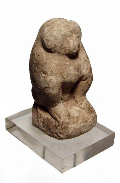 Egypt. Limestone figure of Thoth as a baboon: A limestone figure of Thoth as a baboon, Late Period, c. 664-30 BC, sitting on his haunches, front paws on his knees, tail swept around left side. Intact with some wear and age deposits. L: 2 5/8" (6.