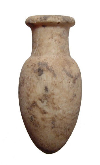Middle Kingdom Egypt, alabaster cosmetic jar: A Middle Kingdom alabaster cosmetic jar, c. 2055-1650 BC, with ovoid body tapering toward base, tubular neck and thick, round rim. Intact with earthen deposits. L: 74 mm (3"). Ex Cecil Best collection