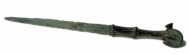 Bronze dagger with ornate handle, Western Iran: A bronze dagger with ornate handle, Western Iran, c. 1200-800 BC, the lower part of the hilt in imitation of an inlaid flanged hilt complete with guard flanges, the upper part tapering to a pommel div