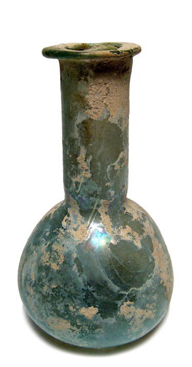 Attractive Roman pale blue-green bottle: An attractive Roman pale blue-green bottle, c. 1st-2nd Century AD, the body pear-shaped with flattened base, neck tubular and rim flattened and turned inward. Intact with earthen deposits and light ir