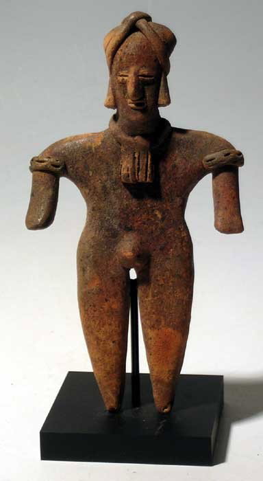 Choice Colima Terracotta Male Figure: An excellent Colima male figure from West Mexico, c. 300 BC – AD 300. He is 6” high, posed standing and is adorned with an elaborate headdress, complex necklace and incised arm bands. Strong miner
