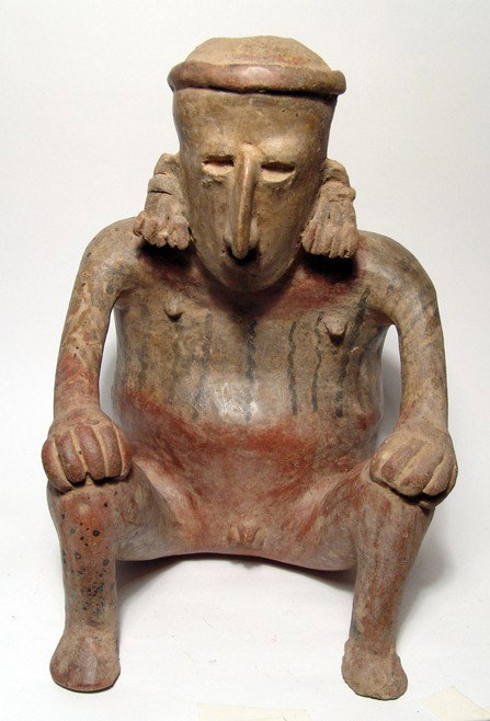 A Large Jalisco Cuisillos Type Seated Male Figure: A large Jalisco Cuisillos type seated male figure, West Mexico, c. AD 1 - 250, hair pulled back into a knot and wearing elaborate ear ornaments. He is depicted nude, hands resting on his knees, his fe