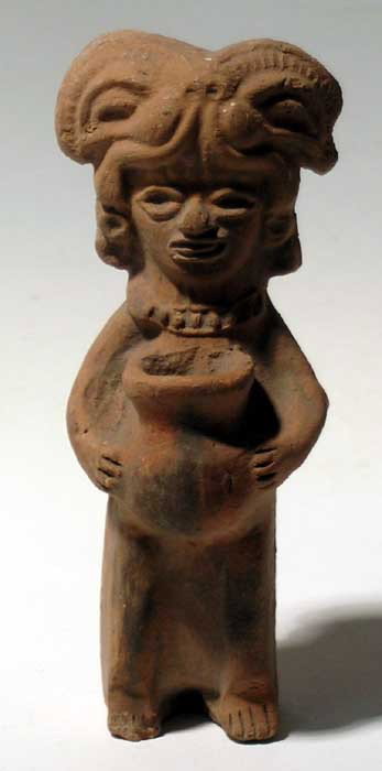 Fine molded Teotihuacan figure from Mexico: A fine molded Teotihuacan figure from Mexico, c. AD 400-650, depicting an individual wearing a complex ceremonial headdress and segmented necklace. He holds a large olla, perhaps containing an offerin