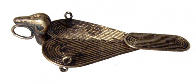 Muisca / Chibcha Tumbaga avian pendant, Colombia: A Muisca / Chibcha Tumbaga avian pendant, Colombia, ca. AD 1000-1500, formed from coiled wire, with each wing section and the tail a separate construction. The head is nicely modeled with a suspension