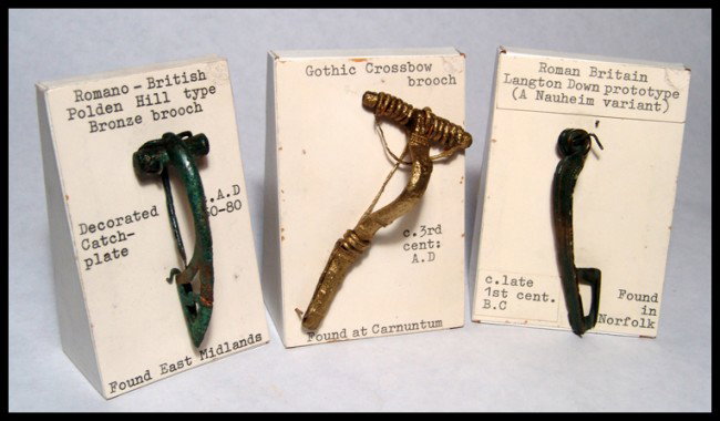 Lot of 3 fibulae from the Hattatt collection: Lot of 3 fibulae from the Hattatt collection. 1). Romano-British Polden Hill type fibula, c. 50-80, with slender bow, short coil and decorated catch plate. L: 2 1/2" (6.4 cm). Cf. Hawkes and Hull, Cam