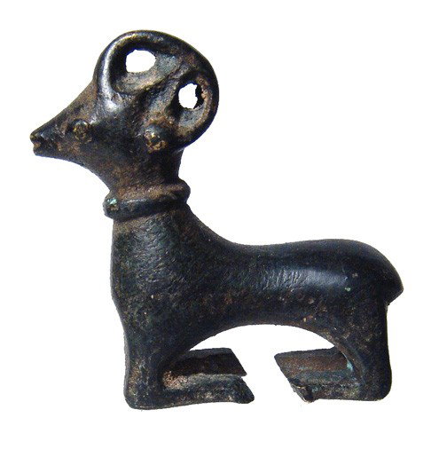 Recumbent bronze ram, Central Asia: An attractive recumbent bronze ram, Central Asia, early 1st Millennium BC, the horns tightly curled atop the head with triangular ear at the center. The face is wife and conical, the eyes almond-shape