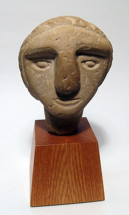 Carved limestone head, style of South Arabia: A carved limestone head in the style of South Arabia, c 6th - 5th Century BC, the back of the head flattened with 5 lines of Simean script. H: 4 1/2" (14.1 cm). (Without stand). A nice art piece and m
