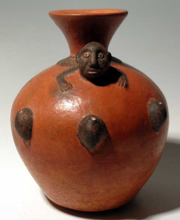 Large Inca jug from Peru, c. AD 1300 - 1500: A large Inca jug from Peru, c. AD 1300 - 1500, featuring a beautifully detailed feline perched atop the chamber, decorated with spots and the long curled tail forms a handle. H: 10 1/4". In excellent 