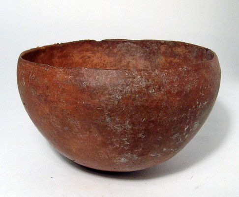 Pre-Dynastic Egypt, terracotta bowl: A Pre-Dynastic terracotta bowl, c. 3900 - 3300 BC, thin-walled with a divit at the base. Some areas of surface loss and a few minor rim chips. H: 3 5/8" (9.2 cm), Dia: 5 3/4" (14.6 cm). Ex English pri