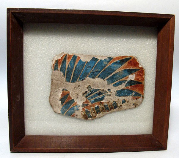 Egyptian painted & framed cartonnage fragment: A painted and framed cartonnage fragment with wing, 3rd Intermediate Period, c. 1075 - 656 BC, with deep blue feathers with an orange ground. 6 1/2" x 4 1/2" (16 x 11.4 cm). Frame measures 10 3/8" x 9