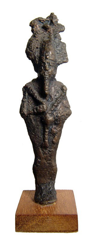 Bronze figure of the god Osiris, Late Period: A bronze figure of the god Osiris, Late Period, c. 664 - 343 BC. The god of the underworld is depicted mummiform, wearing Atef crown with uraeus and false beard, arms crossed over chest, hands holding