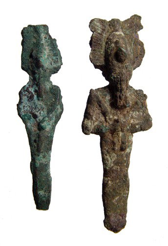 Pair of bronze Osiris figures, Late Period: A pair of bronze Osiris figures, Late Period, c. 664 - 343 BC, each depicted mummiform, wearing Atef crown with uraeus and false beard, arms crossed over chest, hands holding a crook and flail. Larges