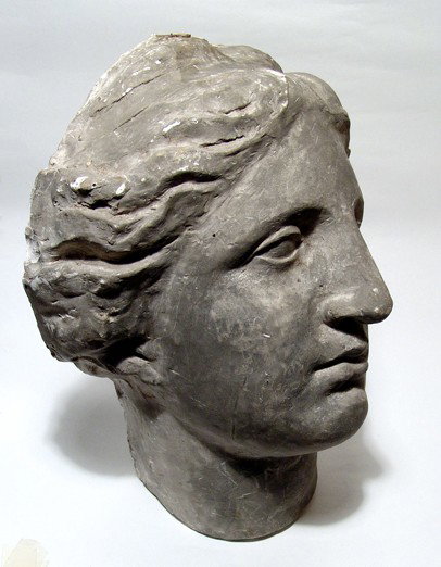 Large plaster wall mount head of Aphrodite: A large wall mount head of Aphrodite, hollow and made from plaster, painted and aged to resemble an ancient original. H: 13 1/4" (33.7 cm). Pleasing style and makes an attractive display piece!