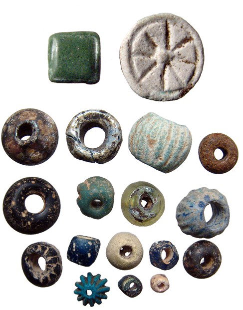 18 glass and faience beads. Egypt & Near East: A group of 18 glass and faience beads. Group includes beads dating from the Late Period of Egypt, c. 664 - 30 BC up to the Islamic Near East, c. 8th - 10th Century. Largest measures 21mm in diameter.