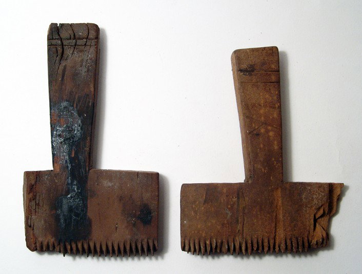 Pair of Coptic weaver's combs, Roman Period: A pair of Coptic weaver's combs, Roman Period, c. 4th - 6th Century AD, of 'T-shaped' construction with teeth only on one side. Parallel lines decorate the base of each handles. Some losses to the sid