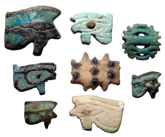 8 faience Wedjat, or 'Eye of Horus' amulets: A group 8 faience Wedjat, or 'Eye of Horus' amulets from various periods. Lot includes examples spanning the Late New Kingdom through the Ptolemaic Period. Each is intact and many with nice blue color