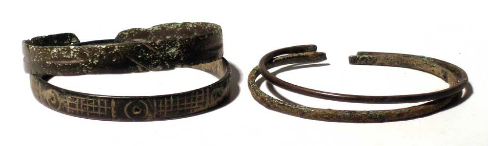 Two pairs of base silver bracelets, Luristan: Two pairs of base silver bracelets from Luristan, c. 1200 - 800 BC. Both pairs are 2 1/2" in diameter, one set is extensively decorated with beautifully hammered designs.