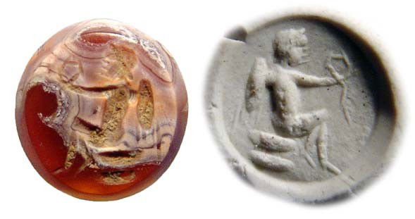 Roman carnelian intaglio depicting Eros: A Roman carnelian intaglio depicting Eros, c. 1st - 2nd Century AD, the winged youthful god seated on cushions, holding a wreath. Intact, the stone with patination. Dia: 11mm. Ex Northern California c