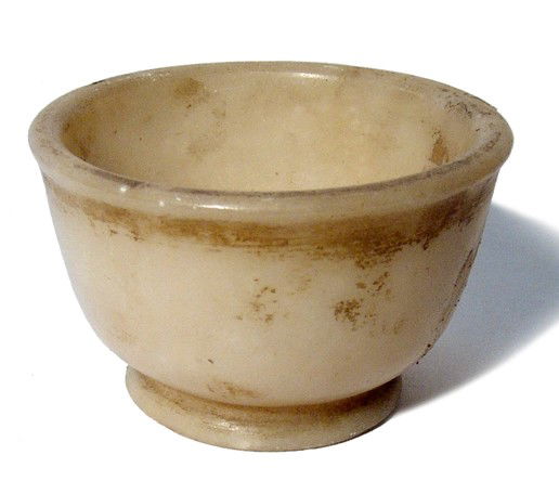 Attractive Kushan alabaster bowl: An attractive Kushan alabaster bowl, c. 1st - 3rd Century AD, thick-walled, with raised disk foot, the outer walls still retaining their glossy polish. Intact with age deposits. H: 2 1/8" (5.4 cm). Ex