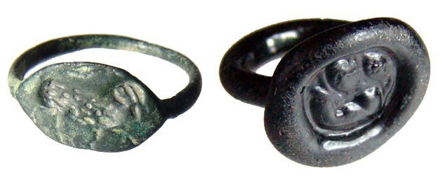 A pair of ancient rings - bronze and glass: A pair of ancient rings - bronze and glass. The first is a Greek bronze ring, c. 4th - 3rd Century BC, with a ram walking rt., bezel measures 16x10mm. Ring size about 9 1/2; the second piece is a