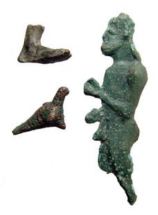 Group of Greek bronze votive objects: A group of Greek bronze votive objects, c. 4th - 1st Century BC, including a standing nude male figure, a foot and a small bird. Largest 3 1/8" (7.9 cm) in length. Each with the inherent light