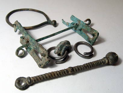 5 misc. bronze objects from Western Iran: A lot of 5 misc. bronze objects from Western Iran, early 1st Millennium BC. The lot includes a bronze horse bit with cheek plate, W: 5 1/2" (13.9 cm) and four other various unidentified items.