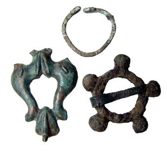 Lot of 3 Roman bronze items: A lot of 3 bronze items including an applique, a broach and a buckle. The first piece is a Roman bronze applique with two dolphins, c. 1st - 3rd Century AD, L: 1 3/4" (4.4 cm). The second piece is a