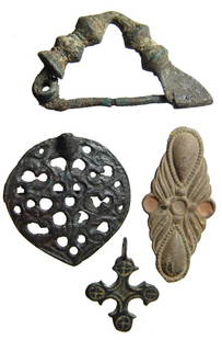 Group of bronzes. Persian, Medieval, Byzantine: A group of bronze objects. Lot includes a Persian arm fibula, c. 5th - 3rd Century BC, L: 53mm; a Medieval plate brooch, c. 13th - 15th Century, W: 36mm; a Byzantine bronze cross, L: 31mm and a