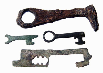 3 Roman keys and a lock bolt: A group of three Roman keys and a single bolt for a lock, Imperial Period. The larger key is of iron, the rest of the pieces are bronze. Lengths from 1 1/4" to 3" (3.2 to 7.7 cm).