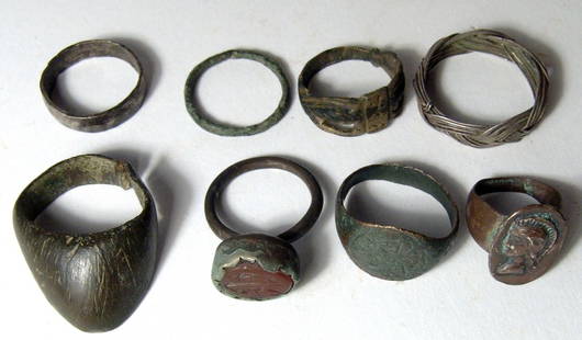 Lot of 8 rings, ancient to antique: A lot of 8 rings, ancient to antique. Lot includes a Roman archer's ring, a Byzantine bronze ring with an eagle, a Persian ring with carnelian intaglio with script, and a mix of others dating from