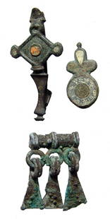 Roman Britain brooches and Luristan element: A pair of enameled brooches from Roman Britain and a Luristan decorative element. The two plate brooches, 2nd - 3rd Century AD, are intact with traces of enamel remaining, one with a lovely star