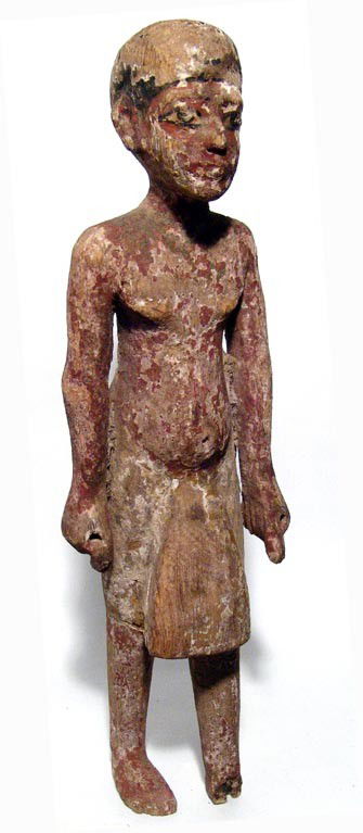 New Kingdom large wooden priest statue: A large wooden statue of a priest, New Kingdom, c. 1570 - 1075 BC, wearing a kilt, hands at his side. Facial features are soft and boyish, body soft as well with protruding belly. Some losses to left
