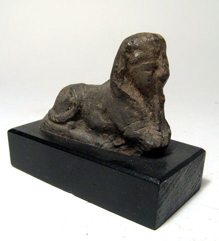 Terracotta sphinx, ex Blanchard's Museum: A Ptolemaic terracotta sphinx, ex Blanchard's Egyptian Museum, c.3rd - 2nd Century BC, in classic pose, wearing Nemes head cloth and false beard. L: 2 1/2" (6.3 cm). Minor losses to front legs. Mounte