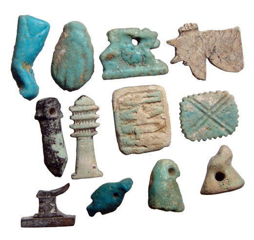 Lot of 12 Egyptian faience & stone amulets: A lot of 12 Egyptian faience & stone amulets. Lot includes a light blue amulet of a cow leg from the New Kingdom and eleven amulets from the Late Period - a Djed pillar of Osiris, a papyrus sceptre, a