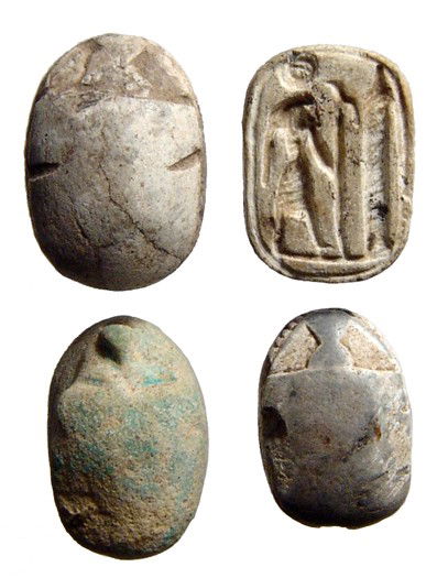 Lot of 4 Egyptian steatite scarabs: A lot of 4 Egyptian steatite scarabs. Lot includes a New Kingdom plaque with Re standing before an obelisk on one side and the name 'Amen-Re'; a 2nd Intermediate scarab with symmetric signs; a 2nd Int