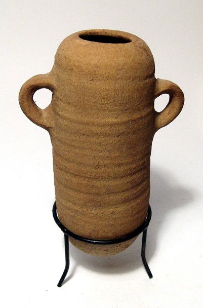 Attractive Phoenician terracotta amphora: An attractive Phoenician terracotta amphora, c. 5th - 3rd Century BC, the body tubular with tapered base and two handles. H: 6 5/8" (16.7 cm). Intact. Ex Thomas Cotterill collection, early 19th Centur