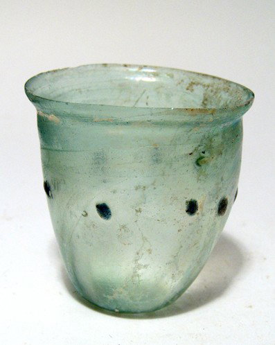 Roman glass beaker, Ex 19th century French coll.: A pale green Roman glass beaker, 4th Century AD, the sides slightly bulging with indented base, rim lightly flared and ground flat. Single deep blue blobs around the center of the body forming a ring.