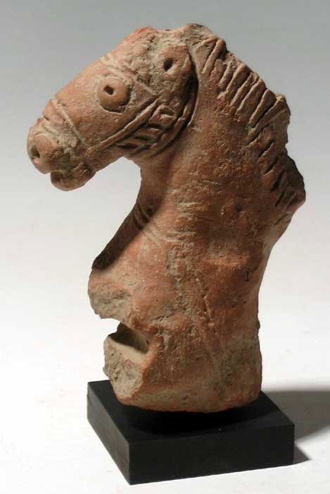 Figural fragment in the form of a horse, Pakistan: A choice figural fragment in the form of a horse, Pakistan, Peshawar Division, 2nd Century BC, in red clay and executed in superb detail, showing the construction of bridle and reins. Nice mineral dep