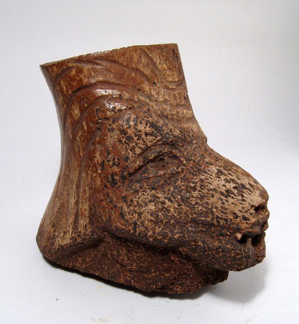 Inuit bone jar in the form of a wolf's head: An unusual Inuit bone jar in the form of a wolf's head made from fossil whale bone, 18th - 19th Century and may well be earlier. The features of the wolf nicely rendered, the base left in the natural 