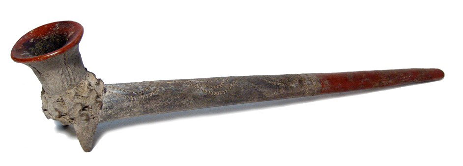 Large Michoacan pipe, vegetal motif, Mexico: A very large Michoacan pipe with vegetal motif, Mexico, c. 200 BC - AD 200. This magnificent burnished red-clay example is highlighted by the addition of an incised serpent design weaving its way alon