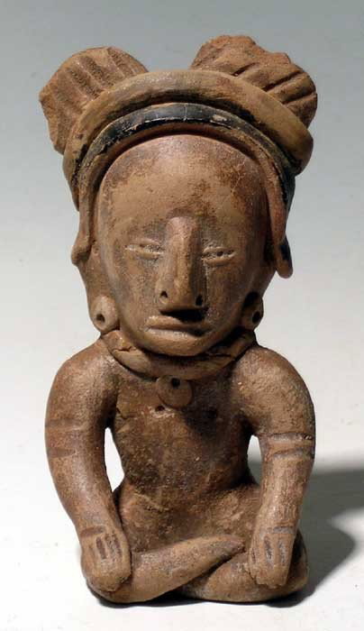 Fine Vera Cruz figure from Mexico: A fine Vera Cruz figure from Mexico, c. 500 - 300 BC, an early Remojadas type and portrayed in the characteristic pose, with hands resting on the crossed legs. He is wearing a fancy headdress with rem