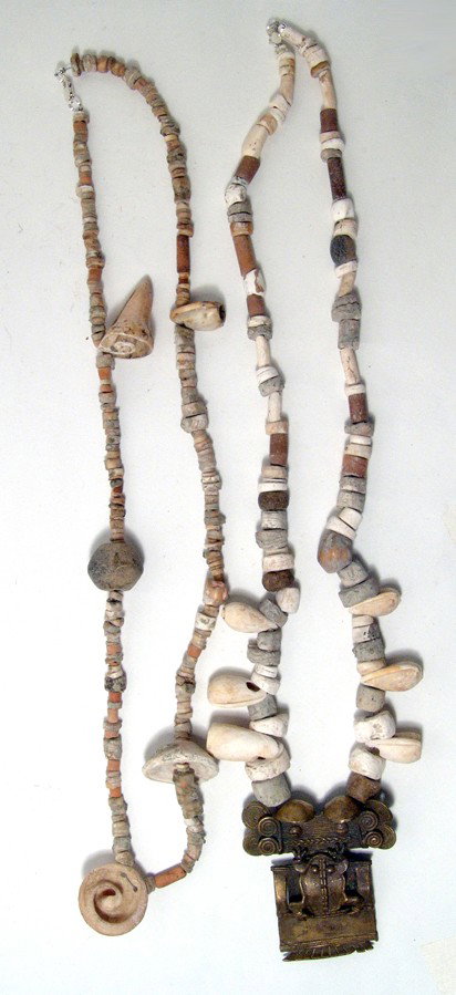 Tairona shell necklace with a large tumbaga: A Tairona shell necklace with a large tumbaga, Colombia, ca. AD 1000 - 1500. The tumbaga is complex and takes the form of a humanoid bearing a frog on his chest. Made from soldered wire and sheet and 