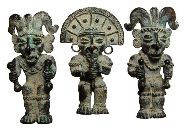 Lot of 3 Tolima copper pendants, Colombia: A lot of 3 Tolima copper pendants, Colombia, c. AD 1000 - 1500, each wearing an elaborate headdress, jewelry and waist girdle. Two of the figures shake rattles and the third plays a wind instrument. E