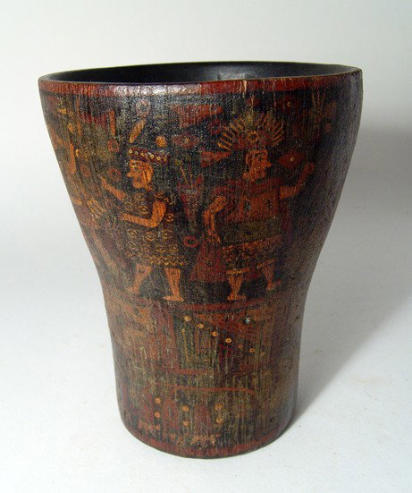 Inca colonial painted wooden kero from Peru: An Inca colonial painted wooden kero, Peru, c. AD 1600 - 1700, with ceremonial scene above rectangular bands of geometric devices, stylized plants below. Intact with some minor retouching of the paint